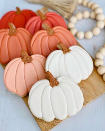 pumpkins and other decorations on a wooden board