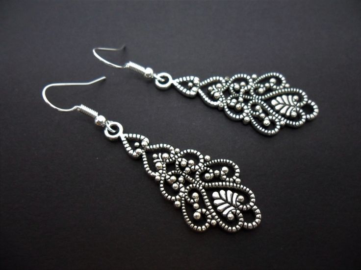 This a pair of pretty tibetan silver dangly filigree earrings. Measure approx. 6cm from top of hook to bottom of earring. These earrings are for pierced ears. Freshly made by me and unworn. Thanks for looking!! Gunmetal Jewelry, Charm Bookmark, Filigree Earrings, Black Feathers, Dangly Earrings, Jade Beads, Cross Charms, Celtic Knot, Pierced Ears