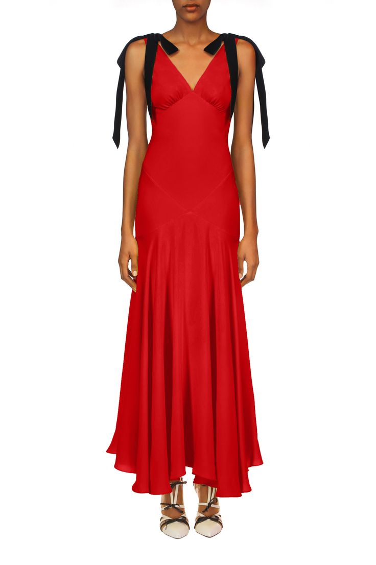 Cut on the bias in lustrous red silk two ply crepe, this bias cut gown features an inlay of cross body panels, echoed by black velvet bows that tie over the  shoulders. The empire waistline gently flares to a maxi length, and is fit to perfection. This dress is lined with a complimentary red silk crepe. Model wears siz Red Silk Bias Cut Maxi Dress, Red Bias Cut Slip Dress, Luxury Pre-draped Bias Cut Slip Dress, Luxury Bias Cut V-neck Maxi Dress, Luxury Red Bias-cut Dress, Black Velvet Bow, Empire Waistline, Velvet Bow, Red Silk