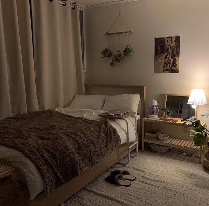 a bed room with a neatly made bed next to a night stand and two lamps