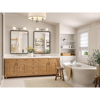 a bathroom with two sinks, a tub and large mirrors on the wall above it