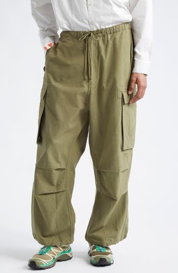 Artisan craftsmanship lies at the heart and soul of these parachute-style cargo pants entirely dyed by hand and detailed with hand-embroidered cross-stitching. 27" inseam; 23" leg opening; 14 1/2" front rise; 20 1/2" back rise (size Large) Drawstring waist Front flap pockets; back flap-patch pocket; cargo bellows pockets 100% organic cotton Machine wash, line dry Imported Designer Clothing Asian & Pacific Islander Owned/Founded Relaxed Fit Cotton Combat Parachute Pants, Spring Cotton Combat Cargo Pants, Spring Combat Cotton Cargo Pants, Spring Combat Cotton Pants, Cotton Combat Parachute Pants With Straight Leg, Combat Style Cotton Parachute Pants With Straight Leg, Combat Style Cotton Parachute Pants, Full Length Cotton Combat Parachute Pants, Military Style Cotton Parachute Pants