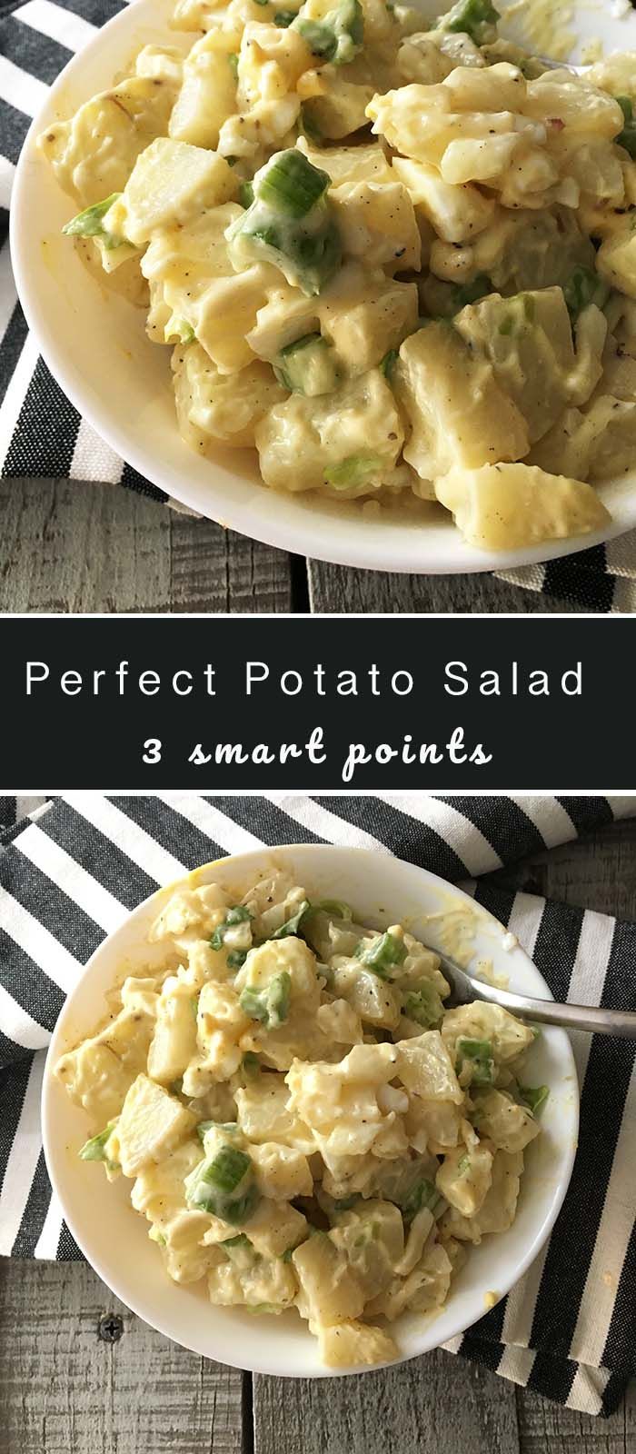 two plates filled with potato salad on top of a striped table cloth and black and white napkin