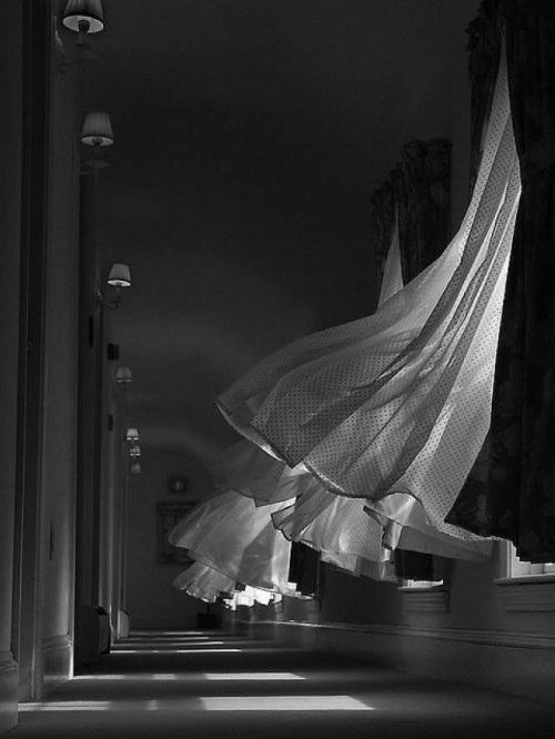 a black and white photo of an empty hallway