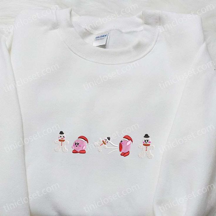 Kirby Eating Snowman Embroidered Shirt, Game Character Embroidered Hoodie, Christmas Embroidered Sweatshirt Within the whimsical realm of fashion, Tinicloset stands as an oasis of creative expression, offering an extraordinary collection of custom embroidered apparel that beckons you to embrace the delightful and the unexpected. As you step into our world, prepare to be drawn into a captivating narrative that unfolds through our unique designs. Our store isn’t just a shopping destination; White Embroidered Winter Tops, Winter White Embroidered Tops, White Hoodie With Embroidered Text For Winter, White Winter Hoodie With Embroidered Text, Winter White Hoodie With Embroidered Text, White Hooded Top With Custom Embroidery, White Hooded Top With Machine Embroidery, Hooded Tops With Machine Embroidery For Winter, White Embroidered Hooded Hoodie