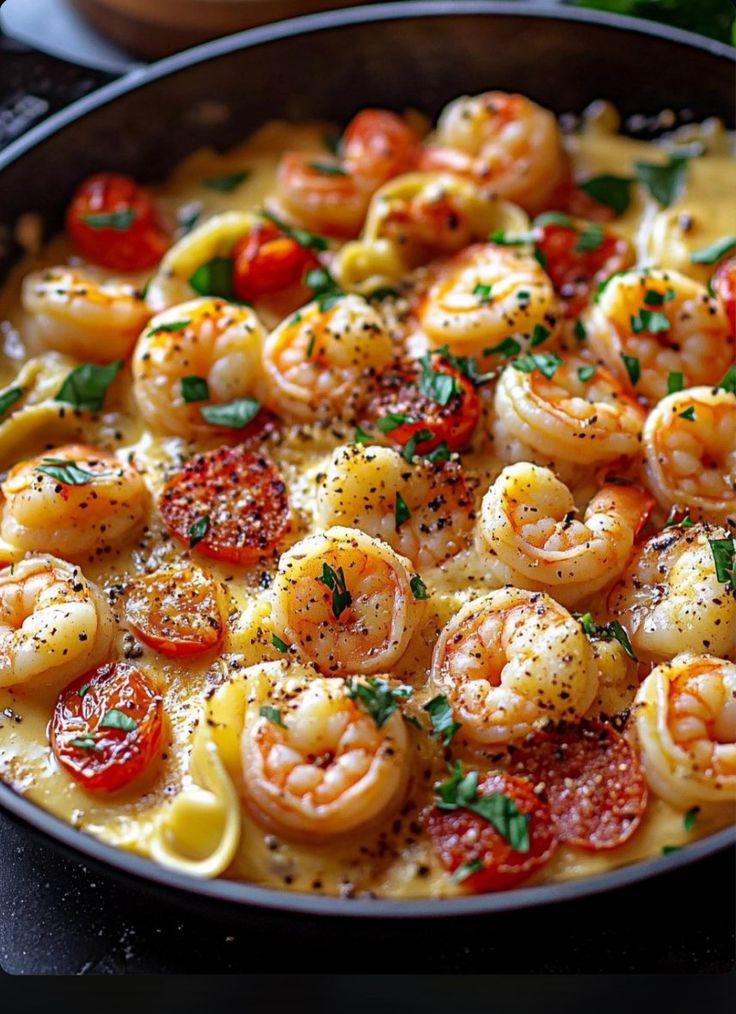 a skillet filled with pasta and shrimp