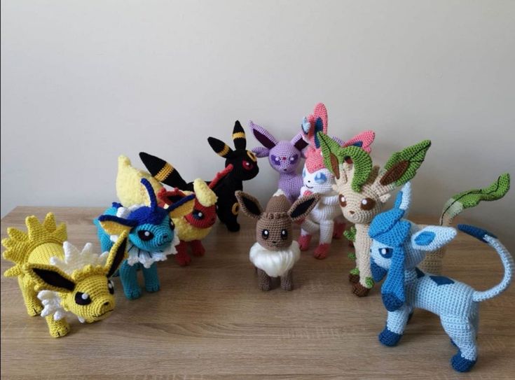 a group of pokemon figurines sitting on top of a wooden table