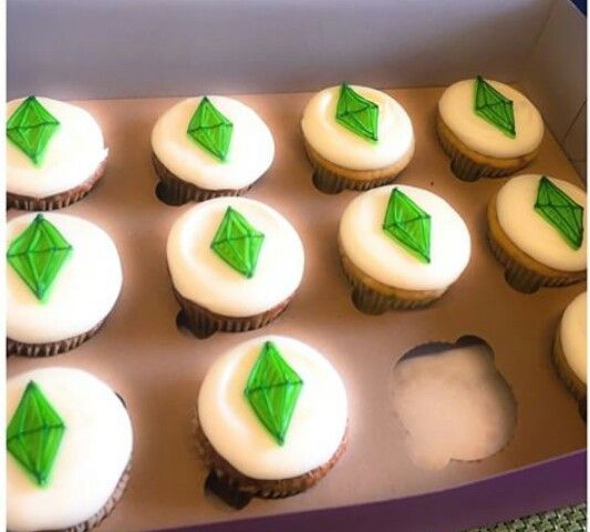 cupcakes with white frosting and green decorations