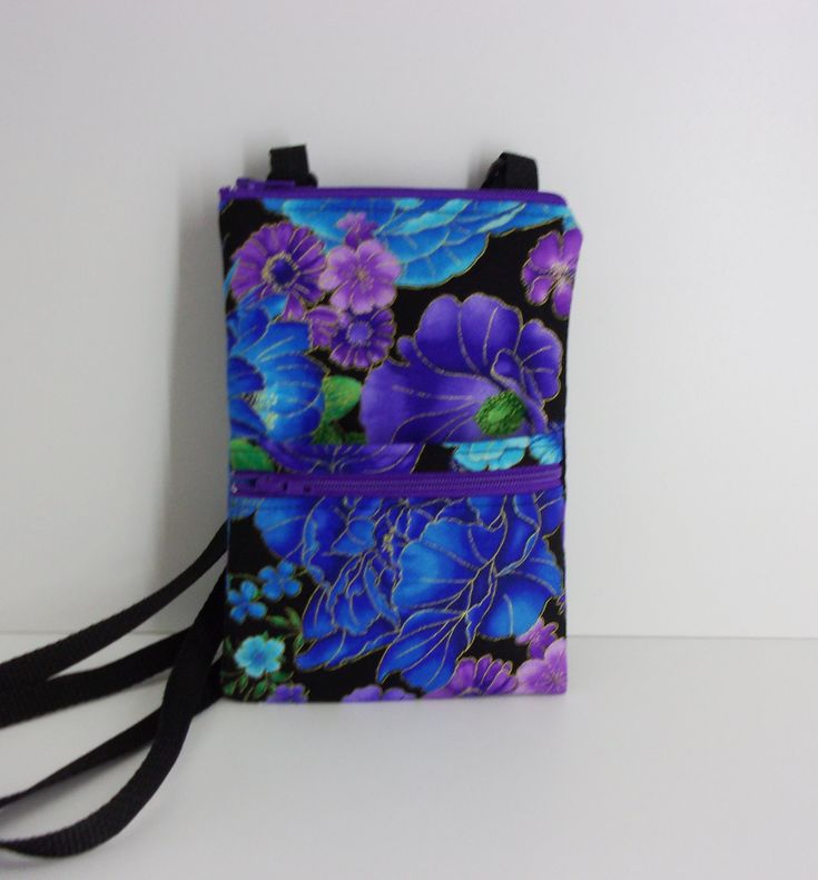 "The cross-body bag in this listing features a stunning floral print with purple, turquoise, blue flowers, and green leaves with metallic accents against a black background. The lining fabric is a coordinating turquoise print. The black webbing strap is adjustable and can be worn cross-body, as a shoulder bag, or as a hip bag. We designed this purse for the gals who want to carry a minimum of stuff, want something light-weight and comfortable, and want to remain hands free during a busy day of a Blue Shoulder Bag With Cell Phone Pocket, Blue Shoulder Bag With Cell Phone Pocket For Gift, Blue Phone Bag With Adjustable Strap As Gift, Blue Phone Bag With Adjustable Strap For Gift, Blue Floral Print Travel Bag, Blue Floral Print Shoulder Bag For Travel, Purple Floral Print Bag For Everyday Use, Everyday Purple Bag With Floral Print, Hipster Bag