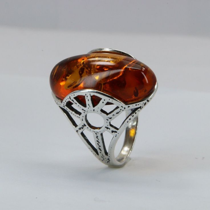 This is a genuine and beautiful Baltic Amber Ring in solid .925 Sterling Silver. The ring has no nickel or other substances causing most allergies and can be considered hypoallergenic. It's right from the amber capital of the world: Gdansk/Danzig, Poland. Size of the Amber 2.2 x 1.2 cm 0.87 x 0.47 inch Weight of the Ring 3.6 g 0.13 oz Base Metal solid Sterling Silver .925 Stone Used Size Baltic Amber 5 You will receive the item in a gift box - perfect to surprise someone or yourself. Amber Ring, Handcrafted Artisan Jewelry, Gdansk, Baltic Amber, Solid Metal, Base Metal, Solid 925 Sterling Silver, Artisan Jewelry, Cognac