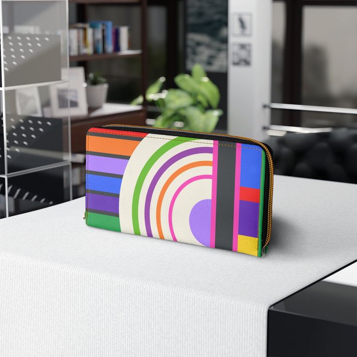 Designed with love and adorned with a colorfully bold abstract bauhaus design, our zipper wallet is made from cruelty-free faux leather, so you can flaunt your unique style without compromising your values! Inside the zipper closure, you'll find pockets designed to hold your cash, credit cards, coins, and checkbook, ensuring your valuables are secure while you are free to go where your carefree spirit takes you! *Note that this item prints and ships from our overseas production partner in China, Modern Multicolor Wallets For Everyday Use, Trendy Multicolor Wallets With Interior Card Slots, Modern Multicolor Rectangular Wallets, Retro Multicolor Wallets As Gifts, Retro Multicolor Travel Wallet, Trendy Multicolor Wallet With Zipper Closure, Trendy Multicolor Wallets With Zipper Closure, Bauhaus Inspired, Bauhaus Design