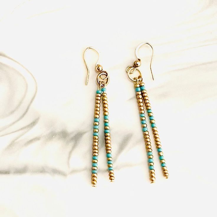 Seed bead earrings/Beaded earrings/Southwest long Beaded earrings/boho earrings/minimalist earrings/western earrings/ Items Details: Handmade Made to order 2 1/4" long Gold and turquoise double strand long dangle earrings. Nickel free ear hook with rubber backs.  New Handmade western earrings. Make a statement with these minimalist style earrings.  Boho earrings.  Comes in a jewelry box and wrapped for easy gift giving.  All Items are created in my smoke free studio. Shipping: Items are shipped US mail and comes with a tracking # and ships in a cardboard box for safe shipping or shipping mailer. Thank you for browsing in my shop if you like my creations please favorite my shop and come back again. I frequently add new items weekly.  Thanks again have a nice day !!     C1C Minimalist Dangle Earrings With Tiny Beads, Dainty Beaded Drop Earrings, Dainty Everyday Earrings With Tiny Beads, Dainty Dangle Beaded Earrings, Colorful Beaded Dangle Earrings For Everyday, Minimalist Adjustable Earrings With Dangling Beads, Handmade Minimalist Beaded Dangle Earrings, Minimalist Beaded Earrings For Everyday, Minimalist Tiny Beads Drop Earrings