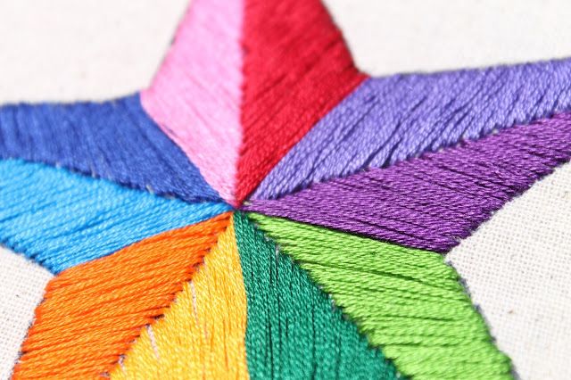 a multicolored star shaped piece of yarn