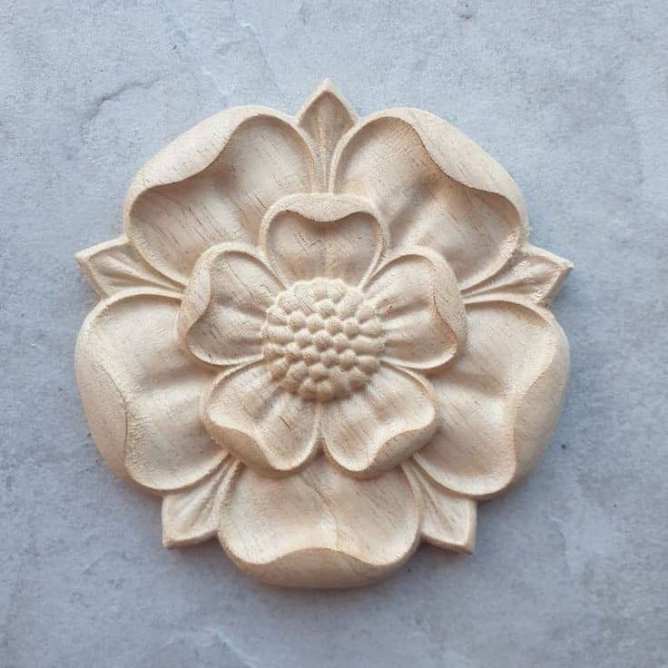 a flower carved into the side of a wall