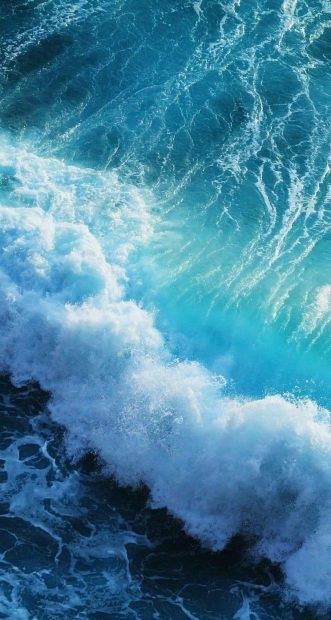 a person riding a surfboard on top of a wave in the ocean