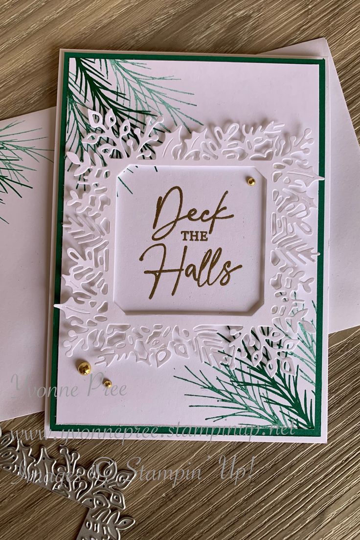 two cards with the words def the falls on them and pine branches in front of them