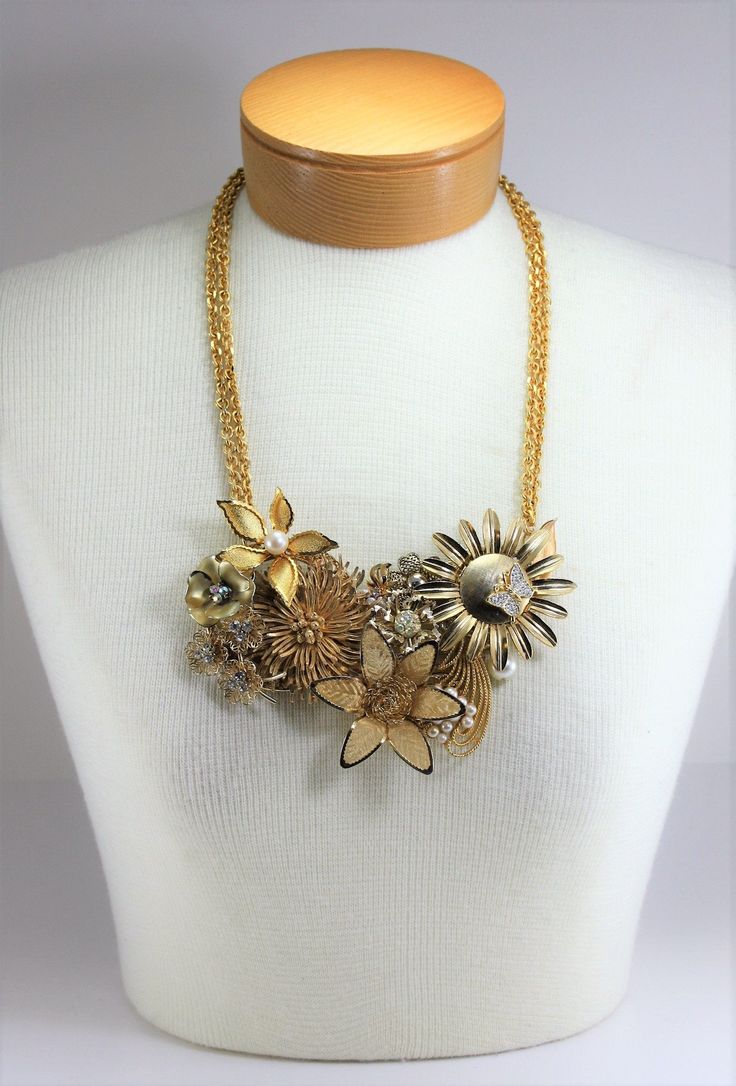 "Vintage Gold Flowers Pearls Rhinestone Metal Assemblage Statement Bib Necklace Handcrafted OOAK. Year around there are always weddings and parties to attend. So I got busy making this wonderful handcrafted necklace blooming with reclaimed vintage gold metal flower pins and other vintage pieces, including pearls and rhinestones, to make this eye catching statement necklace. Vintage gold tone link necklace doubled for added flair! Total drop of necklace is 13\" to bottom of flowers at longest len Gold Rhinestone Crystal Necklace For Celebration, Gold Crystal Bridal Necklace For Celebrations, Gold Rhinestone Necklaces For Celebration, Gold Embellished Wedding Jewelry, Crystal Embellished Necklaces For Wedding, Gold Crystal Rhinestone Necklace For Anniversary, Elegant Embellished Rhinestone Necklace For Wedding, Wedding Crystal Embellished Necklace, Glamorous Embellished Gold Jewelry