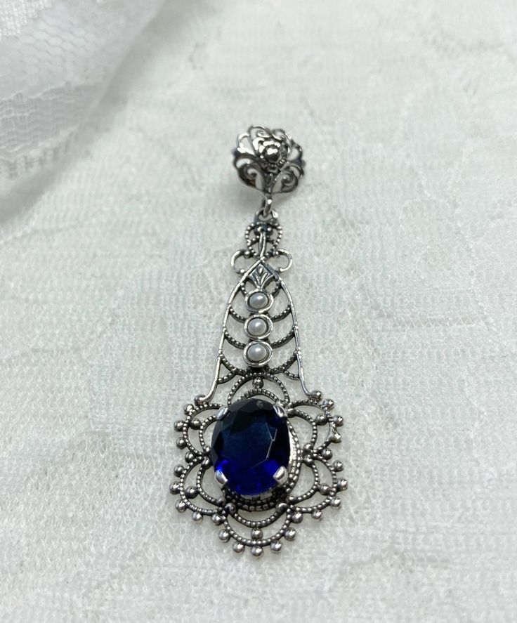 Blue sapphire lavaliere pendant, with three pearls above the gemstone and fancy filigree Floral Filigree, Deep Blue Color, Blue Sapphire Gemstone, Seed Pearl, Blue Necklace, Deep Colors, Sapphire Blue, Sapphire Gemstone, Victorian Era