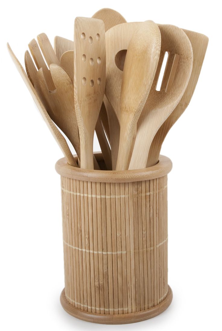 wooden utensils in a bamboo container on a white background