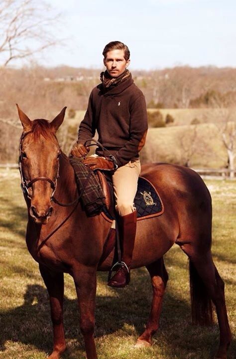 a man is sitting on top of a horse in the grass with trees behind him