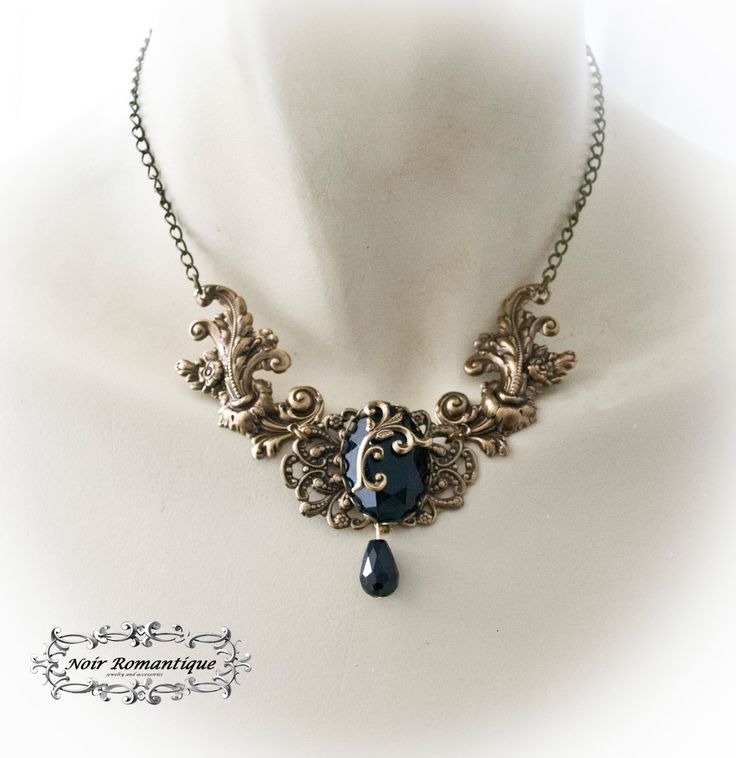 "♥♥Noir Romantique♥♥ Welcome to my store! \"Eternal beauty \"necklace A necklace comprised of 2 bronze rococo flourishes (42x22mm each) perfect detailed set on the left and right of bronze crown setting that is placed upon a central ornament in the middle and finally holds a get black gem 25x18mm. Flourish detail is attached to the gem. Black teardop bead is hanging. ------- If you need a specific lenght contact me :) ------------ ♥♥ The metal parts are of high quality brass ♥♥ Nickel and lead f Gothic Gold Pendant Necklace, Gothic Gold Filigree Jewelry, Gothic Bronze Jewelry With Antique Finish, Gothic Black Necklace For Fantasy Events, Black Gothic Necklace For Fantasy Events, Bronze Metal Fantasy Necklace, Fantasy Style Bronze Metal Necklace, Gothic Pendant Necklace With Antique Finish, Gold Fantasy Style Necklace For Fantasy Events