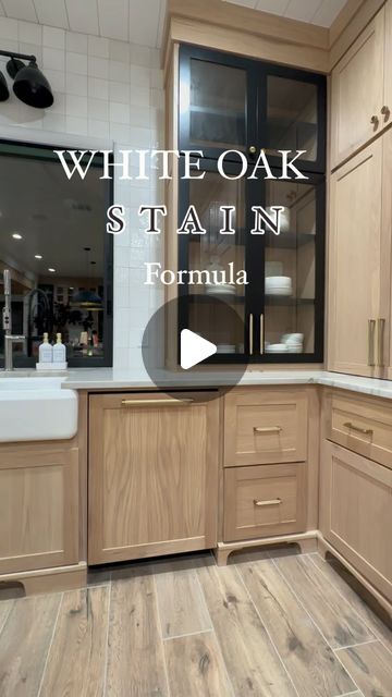 a kitchen with wooden cabinets and white oak stain on the counter top, in front of a large window