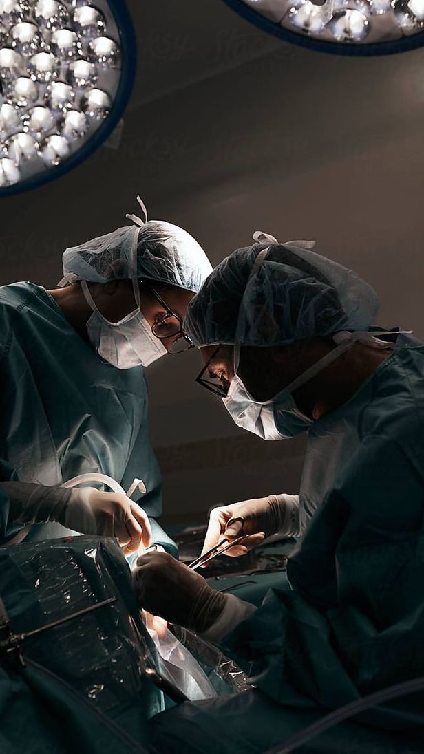 two surgeons performing surgery in an operating room