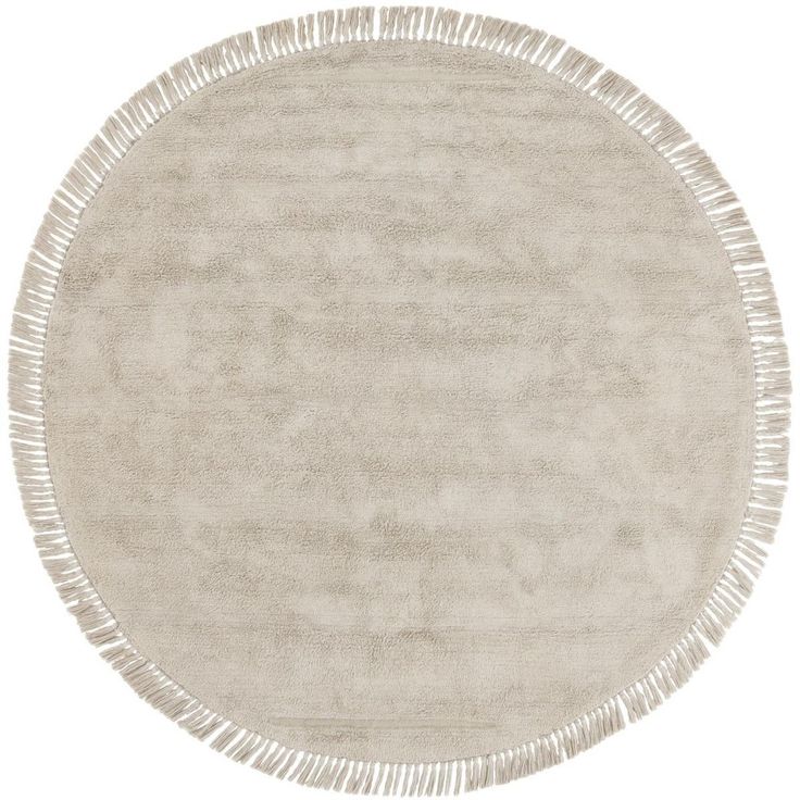 a round rug with fringes on the edges in beige and cream colors, isolated against a white background