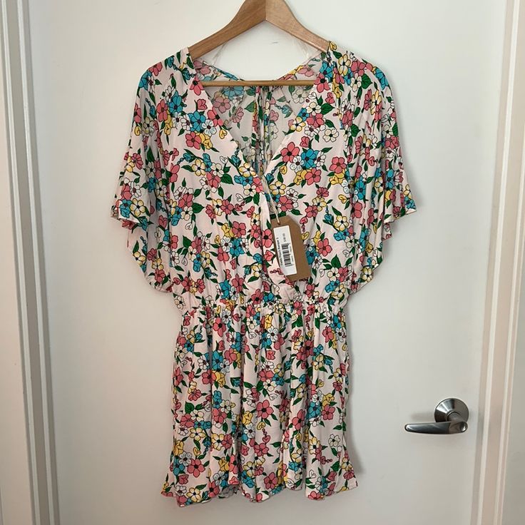 Never Worn- Listicle Flower Print Romper In Size Small. Has Pockets! Lined In Front And In The Shorts. Elastic Waist, Small Button In Front And Ties In Back. Multicolor Floral Print Jumpsuits And Rompers For Day Out, Multicolor Floral Jumpsuits And Rompers For Day Out, Multicolor Floral Print Jumpsuit For Day Out, Casual Floral Print V-neck Jumpsuits And Rompers, Spring Multicolor Floral Jumpsuits And Rompers, Multicolor Floral Print Jumpsuits For Spring, Summer V-neck Jumpsuits And Rompers With Elastic Waistband, Floral Print Jumpsuits And Rompers For Spring Vacation, Summer Floral Print Jumpsuits And Rompers For Loungewear