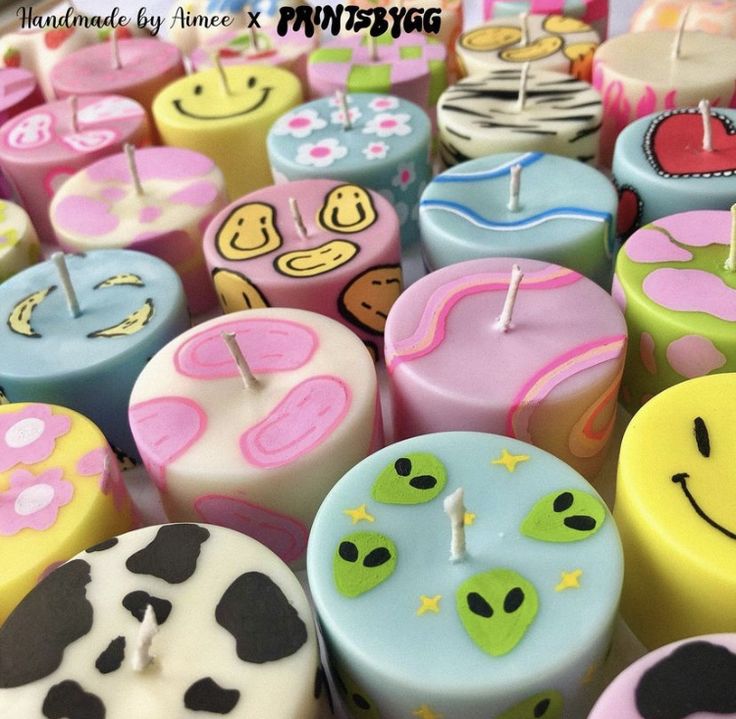 many different colored candles with smiley faces on them