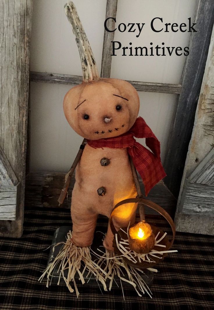 a small stuffed animal with a candle in it's hand and the caption cozy creek primitives