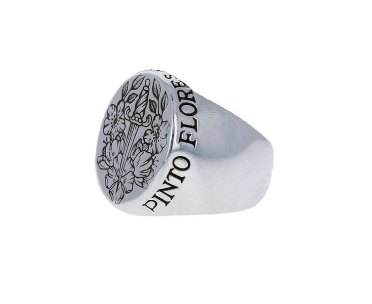 Bold in size, classic in design and honoring one of Modern Art's most inspired women, Frida Kahlo, this Digby & Iona signet ring is a modern version of the traditional. The surface is engraved a floral arrangement bisected by a dagger. 'Pinto Flores Asi No Mueren' is engraved into the sterling silver around the edge which translates to 'I paint the flowers so they will not die' a quote from Kahlo. oxidized sterling silver ring face : 3/4" x 5/8"sterling silver band width : 5mmsize available Fine Jewelry Silver Intaglio Rings, Fine Jewelry Silver Rings With Intaglio, Classic Sterling Silver Intaglio Ring, Symbolic Intaglio Engraved Ring, Symbolic Intaglio Engraved Ring For Anniversary, Silver Intaglio Signet Ring For Wedding, Ceremonial Engraved Open Signet Ring, Silver Wedding Signet Ring With Intaglio, Elegant Formal Signet Ring Stamped 925