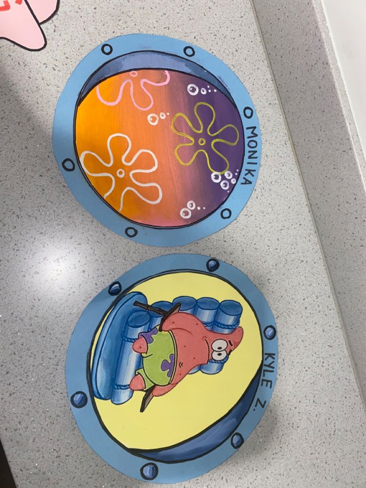 two plates with cartoon characters painted on them