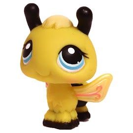 a little yellow toy with big blue eyes and black horns on it's head