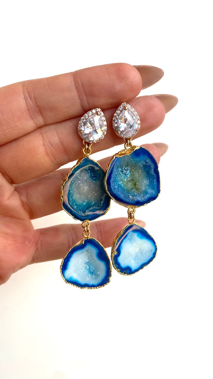 Meet, Aurora! One of our signature seasonless styles! The Aurora earring is always a crowd favorite, especially for brides! She has a hint of glam with CZ post that catches the light and is versatile enough to be worn for day and night. Many of our RM brides purchase Aurora in white or blue (something blue!) for the wedding or bridal shower and wear them over and over again after the wedding. Each and every pair of earrings is truly one-of-a-kind because no two stones are ever the same. The earr Luxury Halo Earrings For Wedding, Round Cubic Zirconia Linear Earrings For Wedding, Sparkling Linear Drop Earrings For Wedding, Luxury Teardrop Linear Earrings For Wedding, Luxury Crystal Bridal Earrings For Wedding, Blue Round Chandelier Earrings For Wedding, Luxury Earrings With Sparkling Stones For Wedding, Blue Halo Earrings For Wedding, Luxury Sparkling Stones Earrings For Wedding