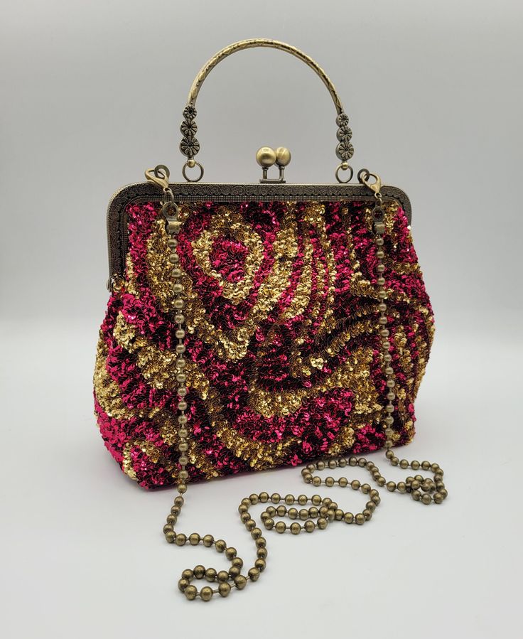 With great pleasure I present this bag, unique piece,entirely made by hands and materials made in Italy. This bag is create with high quality materials such as fabric ,crystals and rhinestones. Each embroidered material is carefully hand sewn. Very glamorous and stylish. Perfect  gift to someone you like.  -------------------------------------------------------------------------- Details: *Metal kiss-lock frame in bronze color long 20 cm (7,8 in) *French vintage sequins. *Lenght of chain 110 cm (43,3 in) *Bag height 20 cm (7,8 in) with handle 28 cm (11,0 in) *Bag width at the bottom 24 cm (9,4 in) *Depth of the bag bottom 10 cm (3,9 in)  The interior of the handbag is lined in black satin fabric with a single pocket enriched with hand embroidered logo, large enough to store cards or lipsti Top Handle Mobile Phone Bag As Gift, Party Mobile Phone Satchel Bag, Top Handle Bag As Gift, Gold Box Bag With Top Carry Handle For Gift, Party Satchel With Mobile Phone Bag, Red Pouch Evening Bag With Detachable Handle, Top Handle Mobile Phone Bag For Party, Multicolor Clutch Mobile Phone Bag, Multicolor Clutch With Mobile Phone Bag