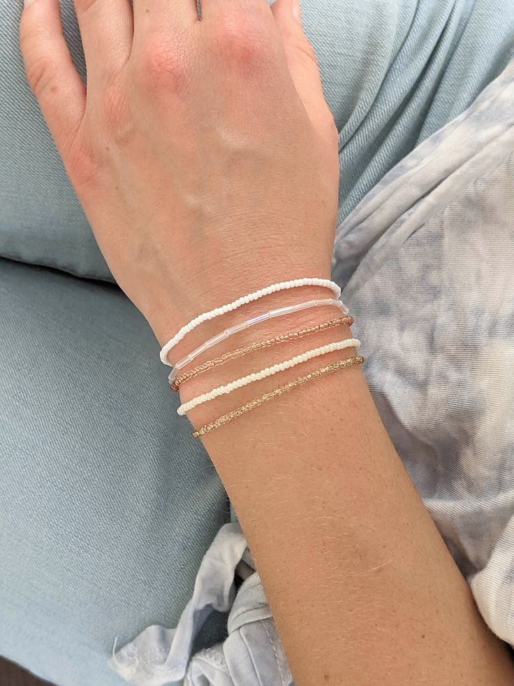 This minimalist bracelet set is so dainty and would make a nice gift. Stack these together, with other bracelets, or wear them by themselves! They are perfect for everyday wear! ∙ ∙ ∙ ∙ ∙ ∙ ∙ ∙ ∙ ∙ ∙ ∙ ◆ MATERIALS ◆ * High Quality Beading Elastic * Seed Beads of Various Colors ∙ ∙ ∙ ∙ ∙ ∙ ∙ ∙ ∙ ∙ ∙ ∙ ◆ SIZES ◆ This bracelet set is made to order so you can order it in whatever size you need. If you need a custom size please let me know. ∙ ∙ ∙ ∙ ∙ ∙ ∙ ∙ ∙ ∙ ∙ ∙ ◆ FINDING THE RIGHT SIZE ◆ You can find out your size by measuring the circumference of your wrist. To do this you can either use a measuring tape or use a piece of ribbon or string. Add about half an inch to the circumference of your wrist for the bracelet size. If you fall between two sizes I recommend getting the larger one. ∙ ∙ ∙ Adjustable Bohemian Bracelet With Delicate Chain, Minimalist Beaded Bracelets With Delicate Chain, Delicate Adjustable Chain Bracelet With Tiny Beads, Minimalist Adjustable White Chain Bracelet, Minimalist White Adjustable Chain Bracelet, Minimalist White Bracelet With Delicate Chain, Delicate White Adjustable Chain Bracelet, Minimalist Adjustable Chain Bracelet With Tiny Beads, Minimalist Beaded Chain Bracelet For Everyday