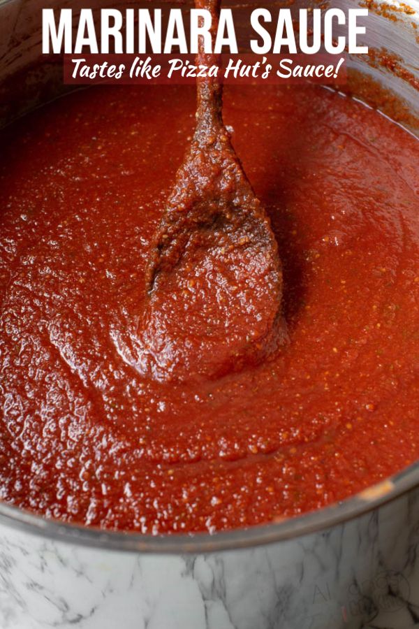 a ladle full of tomato sauce in a pot