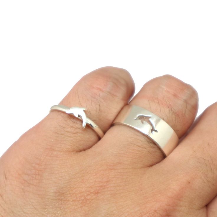 "Dear Dolphin Lovers, are you looking for a gift for anniversary or valentine's day? We have a solution for you and your love one. Why not consider our creation of matching couple ring? It's modern, minimalist and simple to wear and go along with any outfit of your day. Both of this ring is made for men and women. They are matching ring and also a great solution for your proposal promise ring. A simple cut out really makes them pop out. They are comfortable to wear. The women ring can also be us Matching Couple Ring, Ring For Couple, Matching Couple Rings, Dolphin Ring, Fish Ring, Dolphin Lover, Promise Rings For Couples, Mens Fashion Rugged, Matching Ring