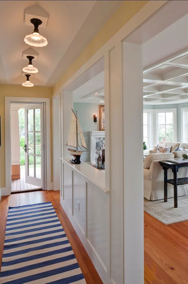 the hallway is clean and ready for guests to use it as an entrance way in this home