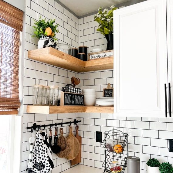 the kitchen is clean and ready for us to use it's shelves are filled with utensils