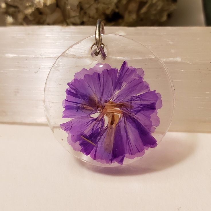 I handmade this pendant using resin and dried flowers.  It will come as completed necklace with 20 in chain. Handmade Purple Resin Necklace, Handmade Clear Flower Necklace, Handmade Resin Flower Pendant Necklace, Resin Necklace With Pressed Flower Pendant, Resin Necklace With Pressed Flowers In Round Pendant, Resin Birth Flower Pendant Necklace, Round Resin Pendant Necklace With Pressed Flowers, Purple Circle, Using Resin