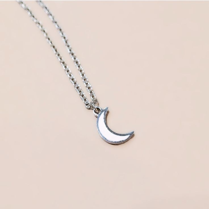 The lumina luna crescent necklace is the first necklace in this collection of specialty curated glow-in-the-dark jewelry. Wear your necklace and charge it with direct light to watch it glow in dark environments. The crescent moon is a pinpoint of the changing of seasons. This time is one for release of anything that is no longer serving you. Wear your lumina luna crescent necklace as a reminder that you are constantly moving through new seasons and if this one is not serving you, the new one is Adjustable Moon Phase Necklace, Adjustable Moon Shape Necklace With Moon Charm, Minimalist Half Moon Clavicle Chain Necklace, Minimalist Half Moon Phase Necklace, White Moon-shaped Clavicle Necklace, Adjustable Crescent Moon Phase Charm Necklace, Minimalist Crescent Moon Phase Charm Necklace, Dainty Moon Phase Charm Necklace, Adjustable Crescent Clavicle Chain Necklace