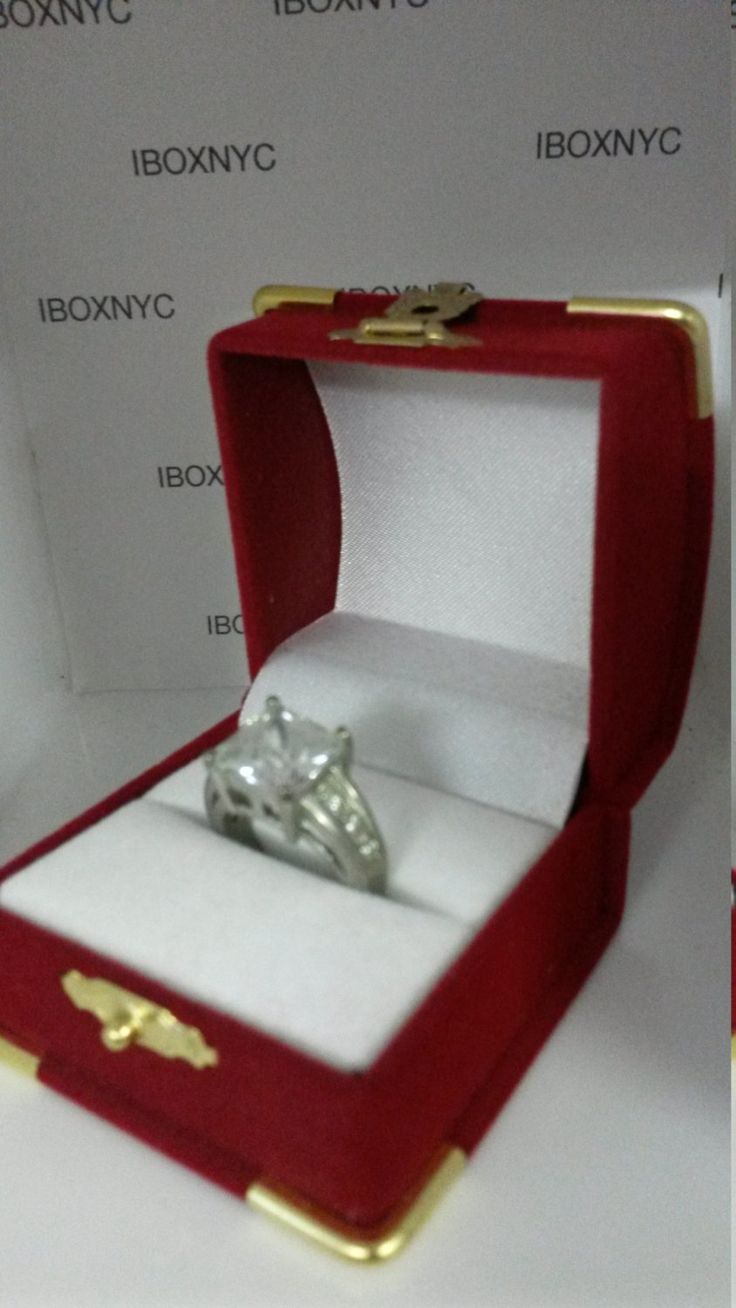 an open red box with a ring inside