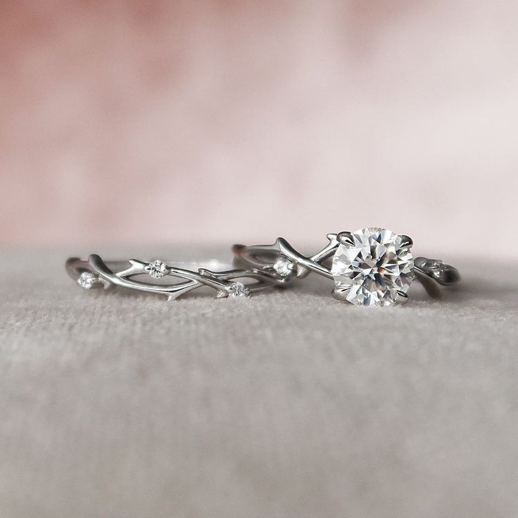 two engagement rings sitting on top of each other