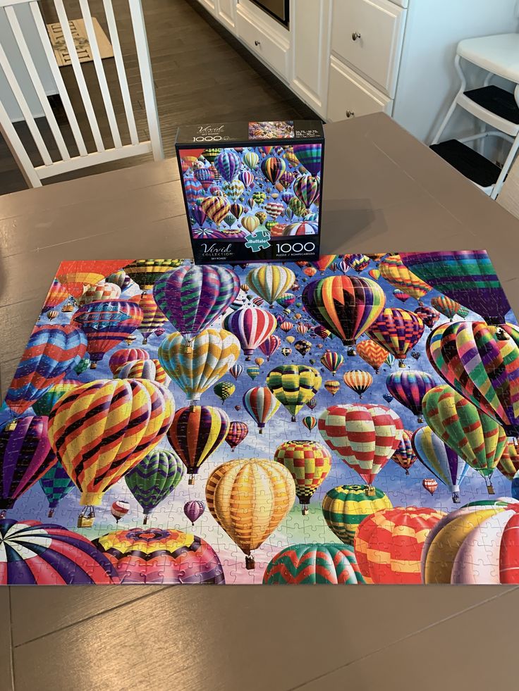 a puzzle box sitting on top of a kitchen counter next to an assortment of hot air balloons