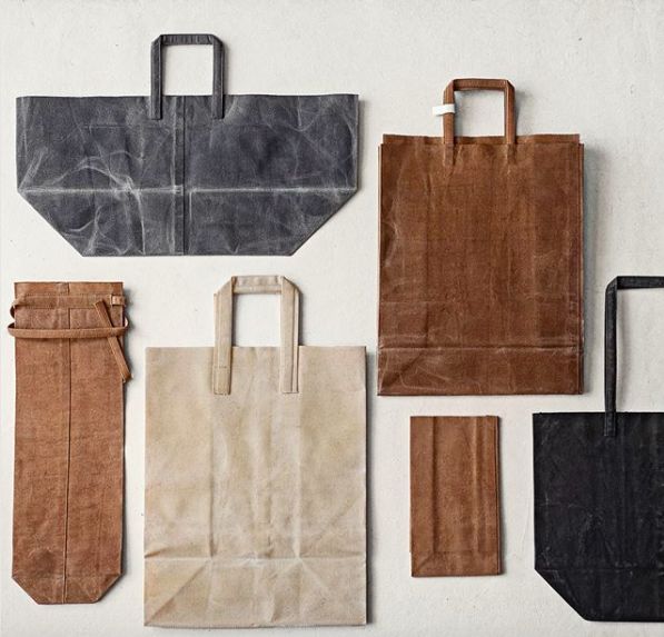 six different types of paper bags on a white surface with one bag in the middle