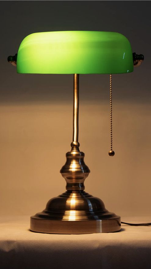 a green lamp sitting on top of a table