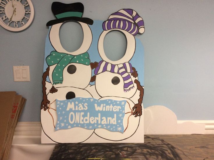 two snowmen wearing hats and scarves are standing in front of a sign that says miss winter oldenland