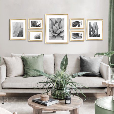 a living room filled with furniture and pictures on the wall above it's coffee table